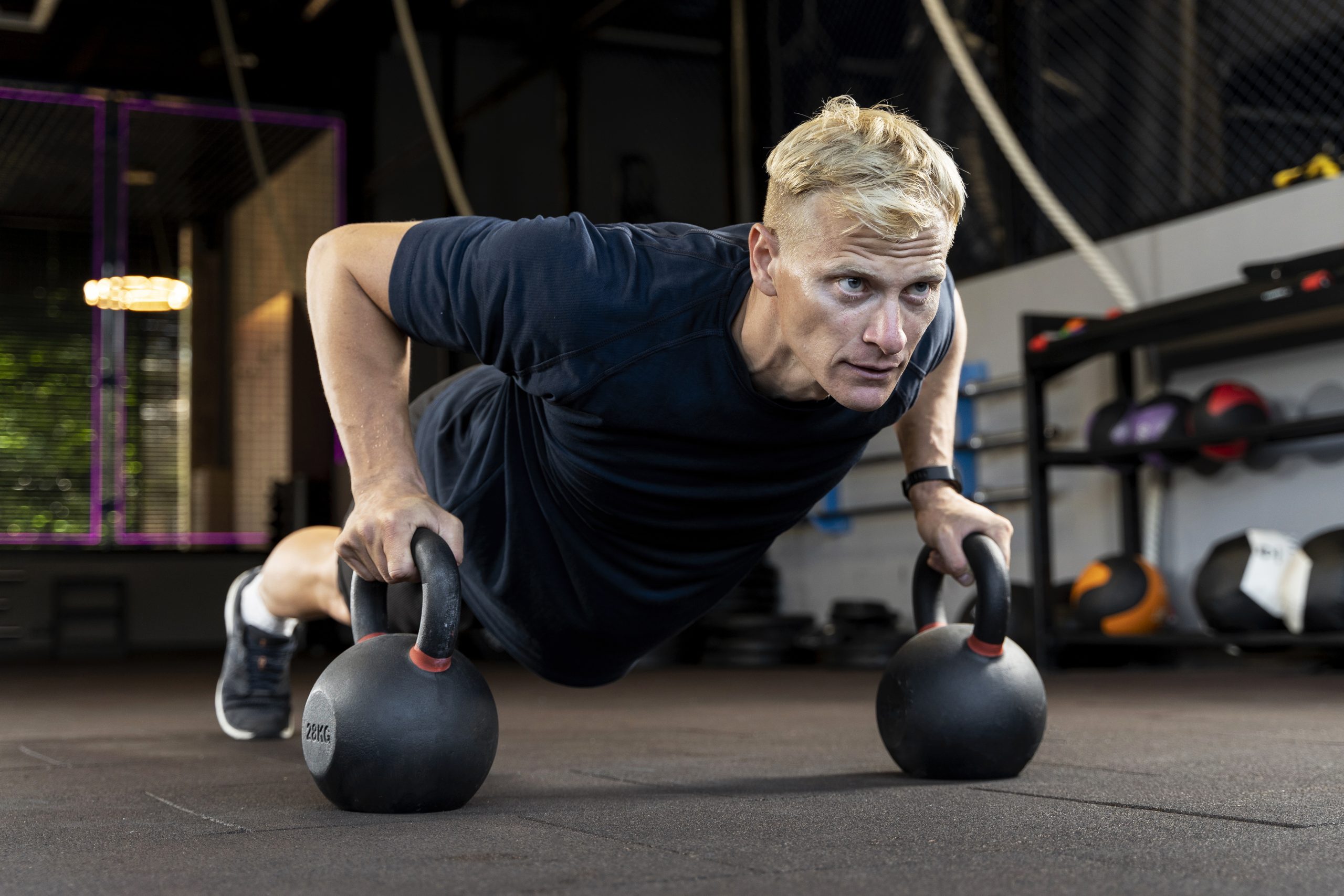 Man doing a strength workout to build lean muscle and firm loose skin