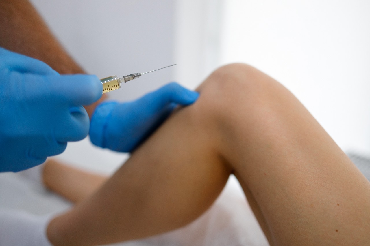 Person preparing a subcutaneous sermorelin injection at home