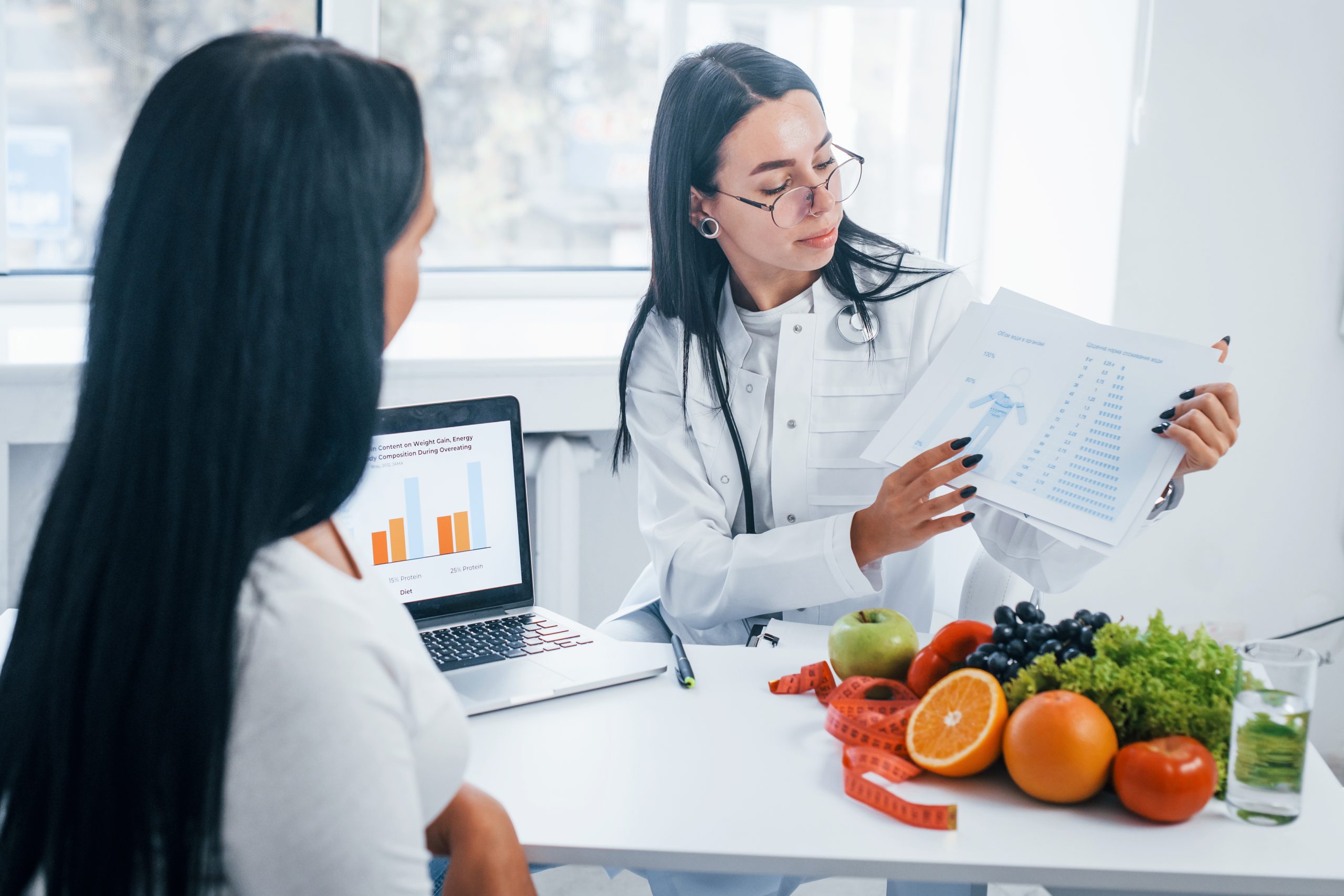Nutritionist reviewing a weight loss plan with a patient in a clinic office