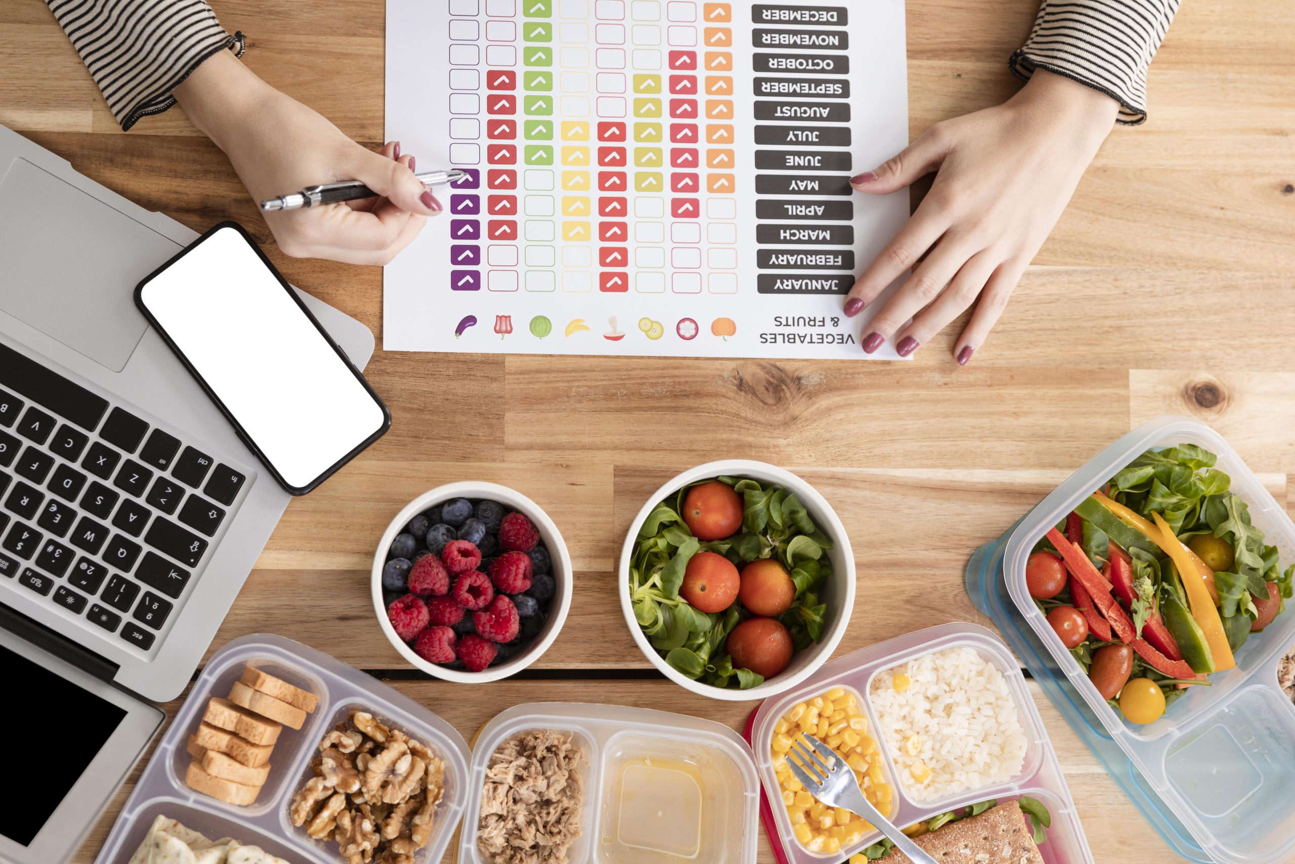 Organic meal-prep boxes and nutrition charts laid out for a balanced fasting plan