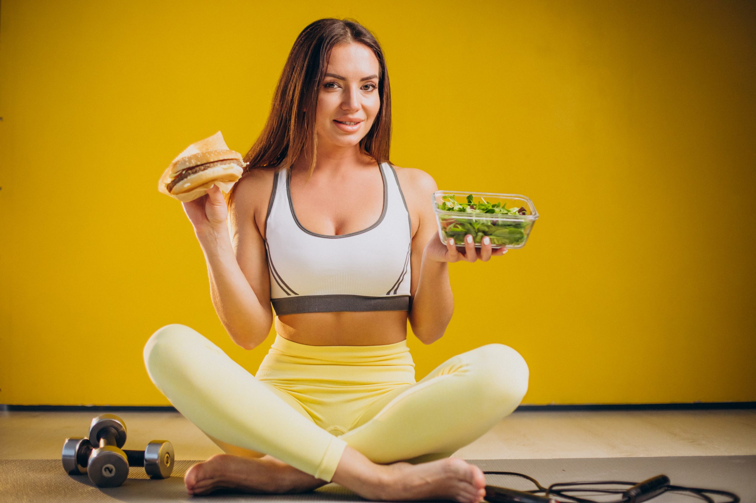 Woman eating a fresh salad, representing a balanced approach to healthy eating