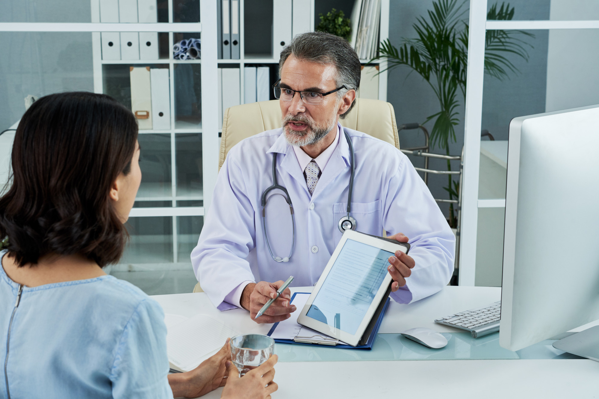Doctor reviewing a patient's results and plan on a tablet