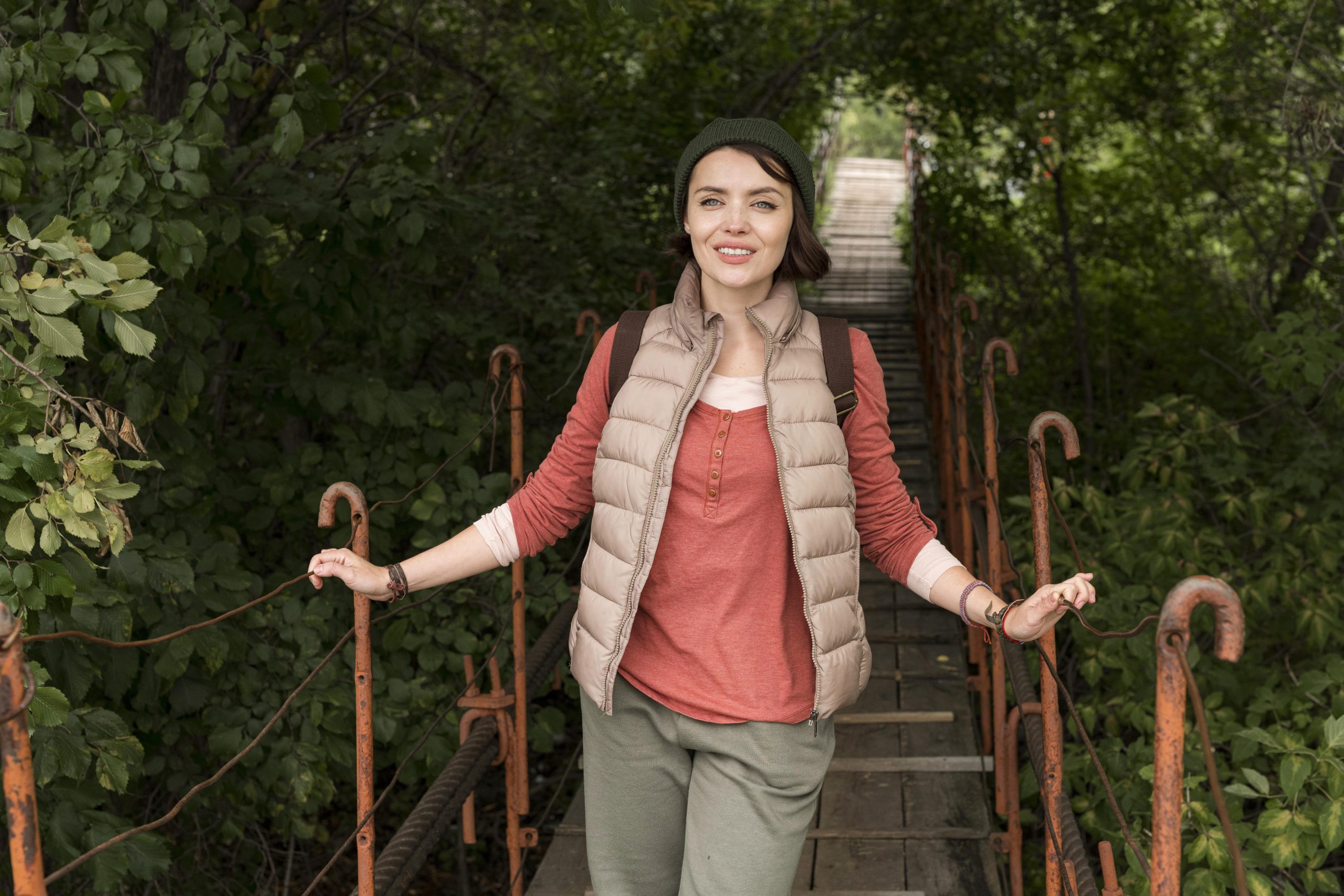 Woman walking across a wooden bridge outdoors