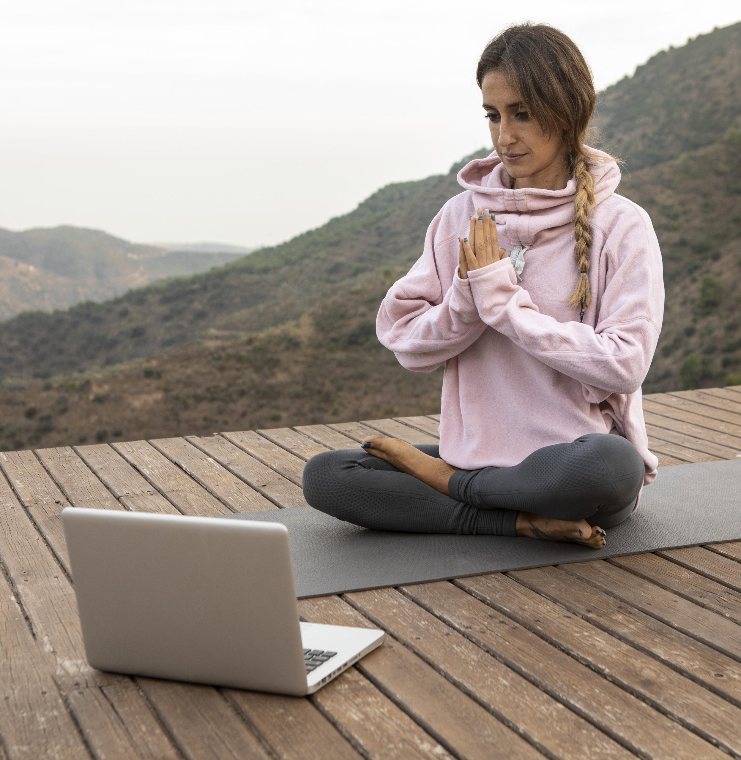 Woman practicing yoga outdoors to unwind and reset mentally