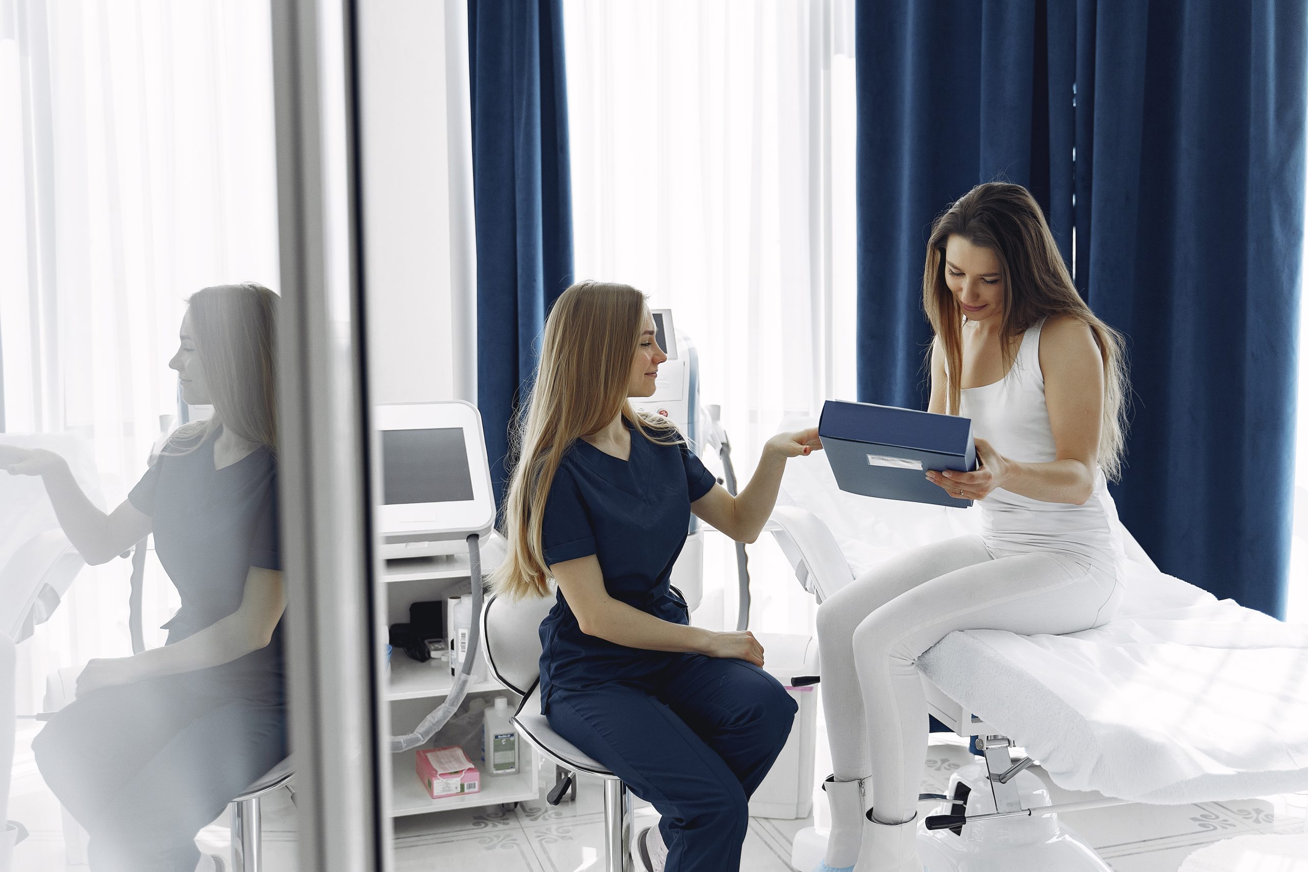 Woman consulting with a doctor in a cosmetology studio