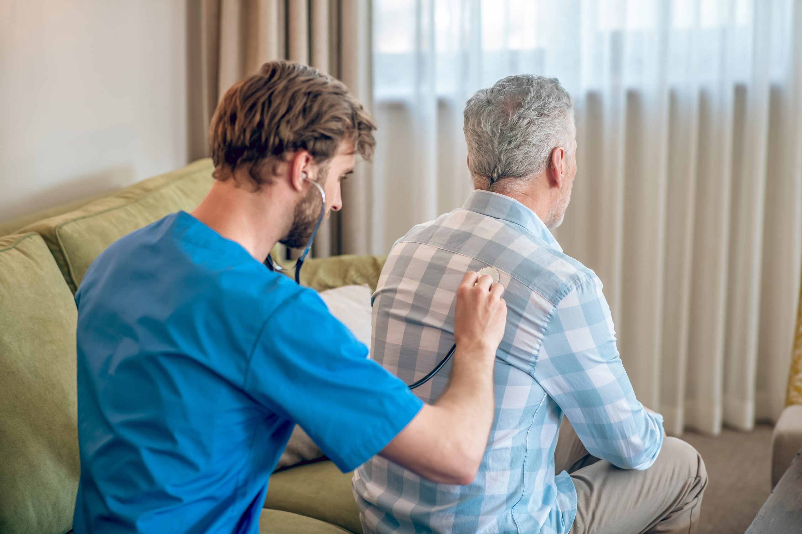 Experienced doctor using a stethoscope during the medical check-up Does Posture Matter in the Aging Process? 3